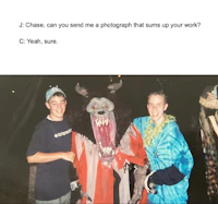 two people standing next to a demon dressed in a costume